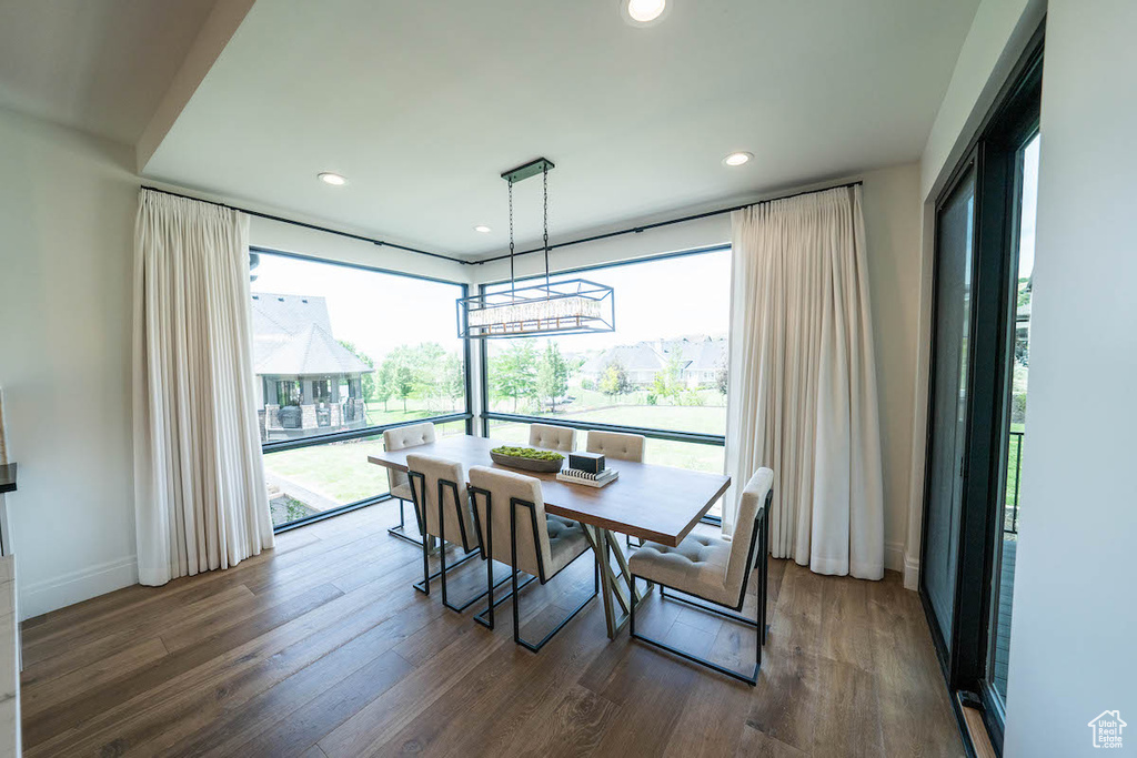 Dining space featuring dark hardwood / wood-style flooring, a chandelier, and plenty of natural light