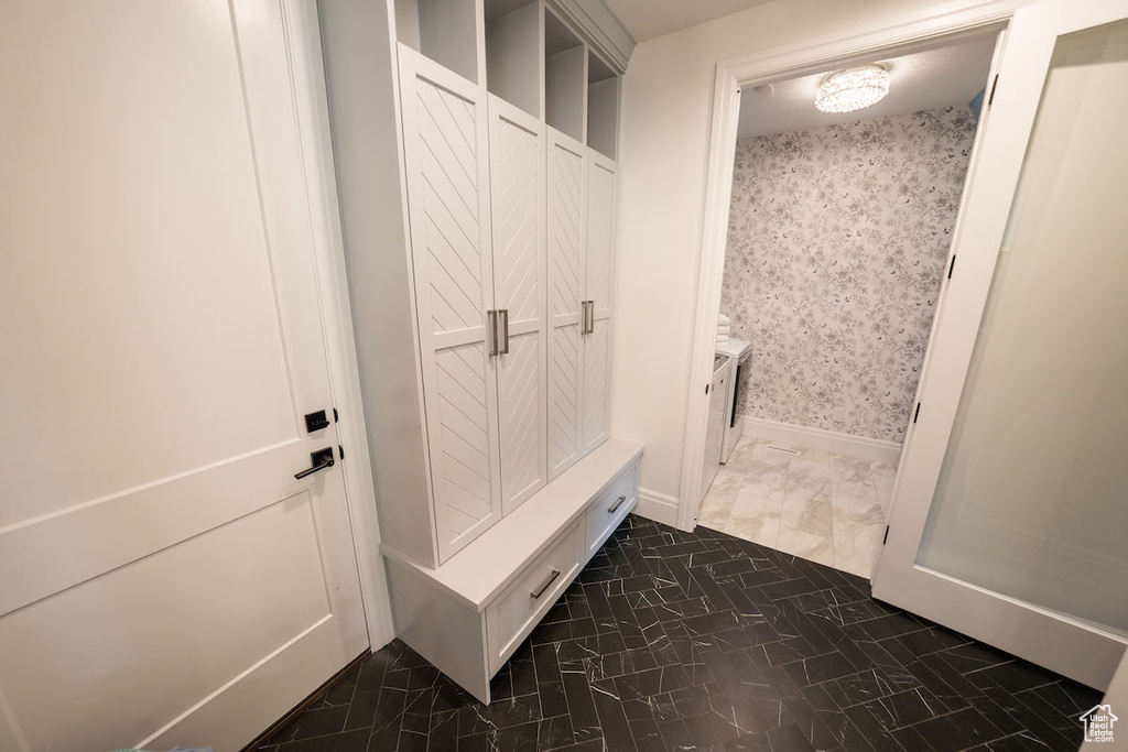 Mudroom featuring dark tile flooring