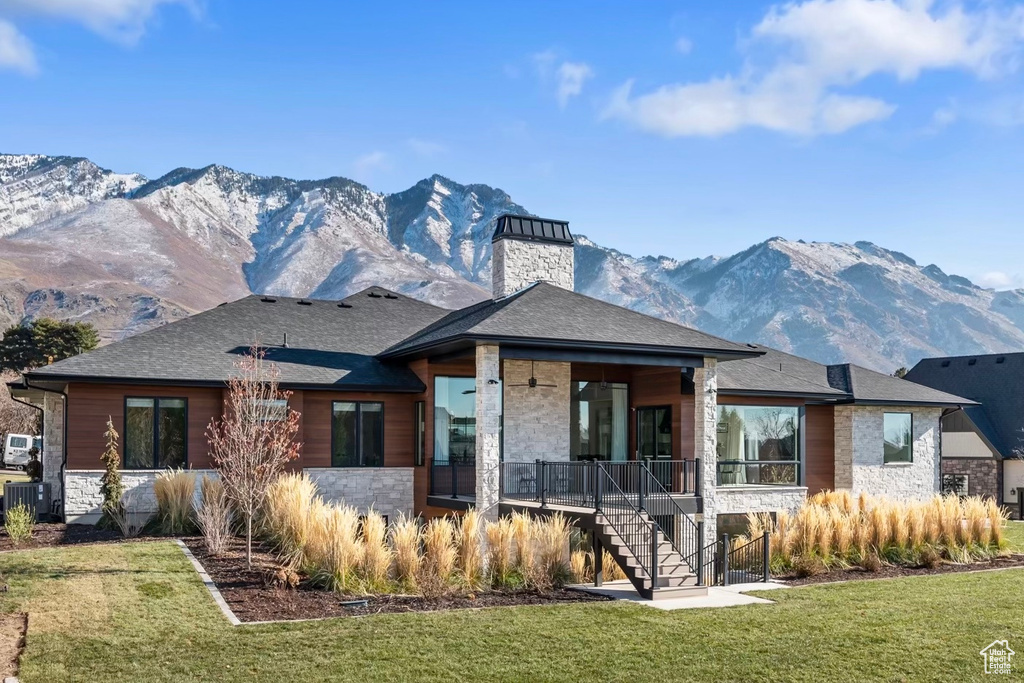 Exterior space featuring a yard, central AC, and a mountain view