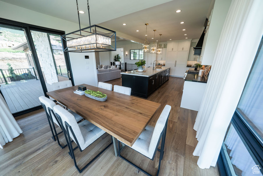 Dining room with sink, a chandelier, and hardwood / wood-style flooring