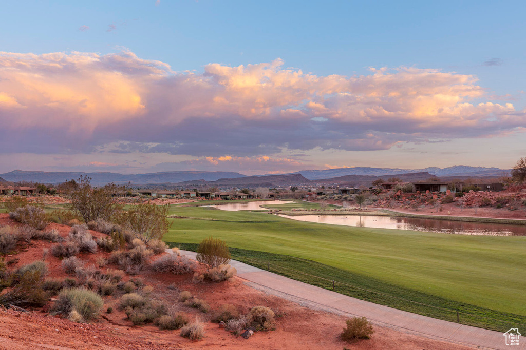 Surrounding community with a yard and a water and mountain view