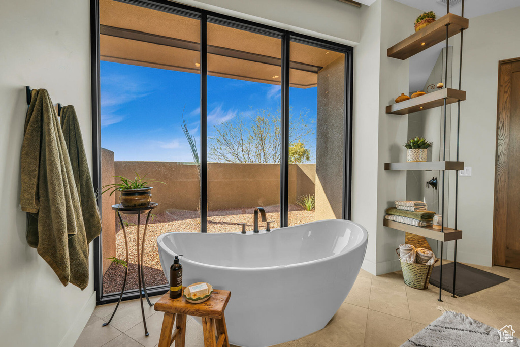 Bathroom featuring tile patterned floors and a washtub