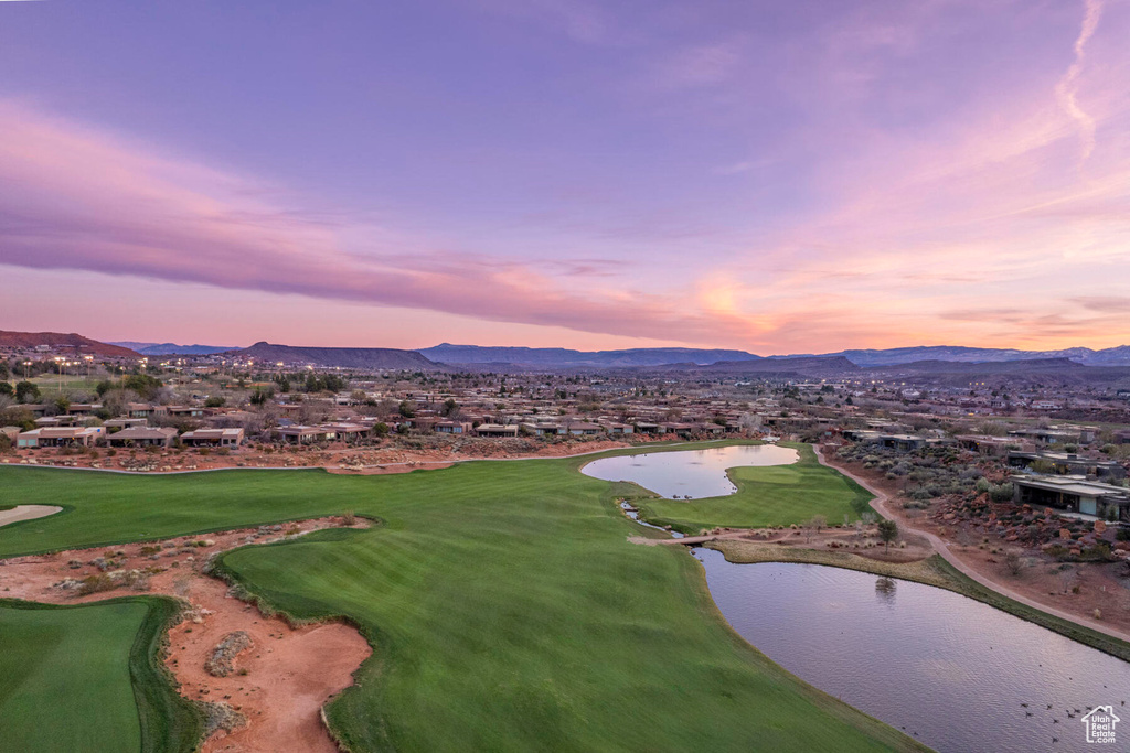 Aerial view at dusk featuring a water and mountain view