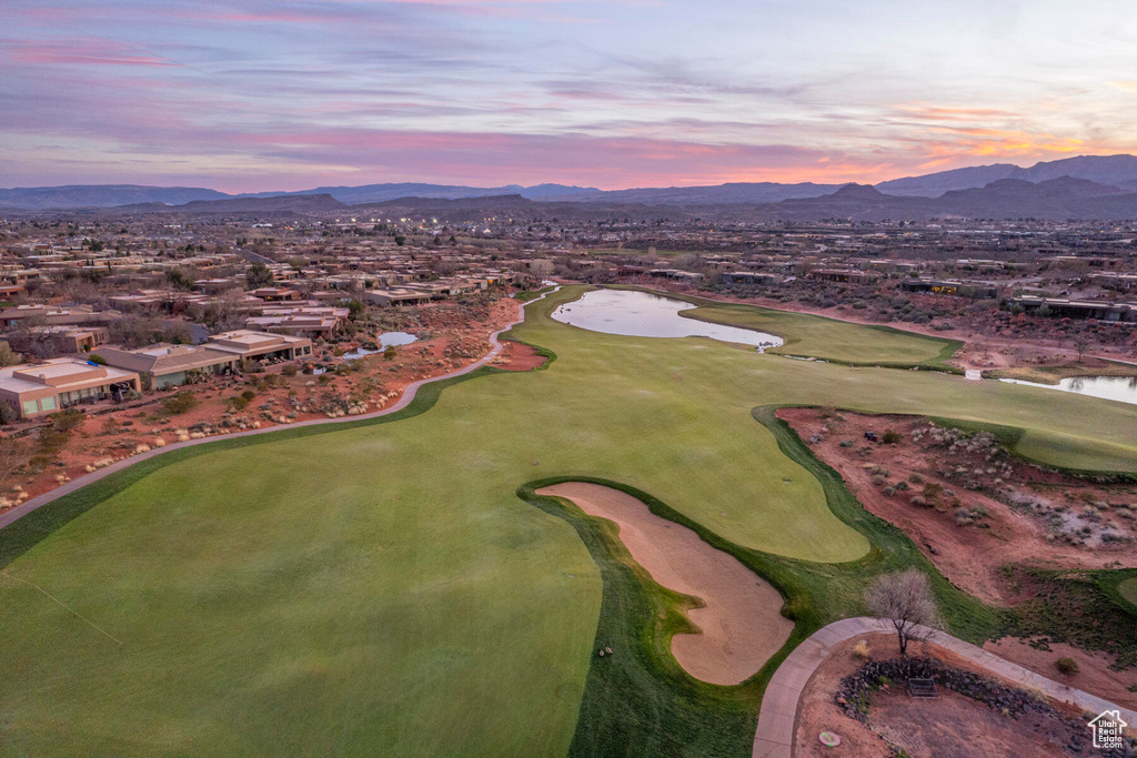 Aerial view at dusk featuring a water and mountain view