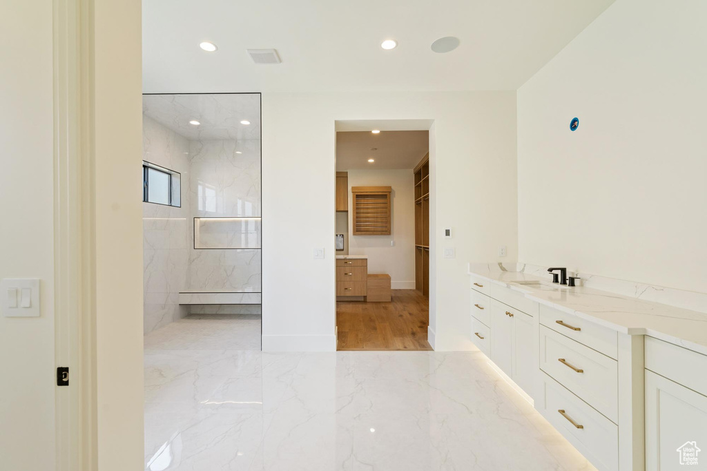 Bathroom featuring vanity and tiled shower