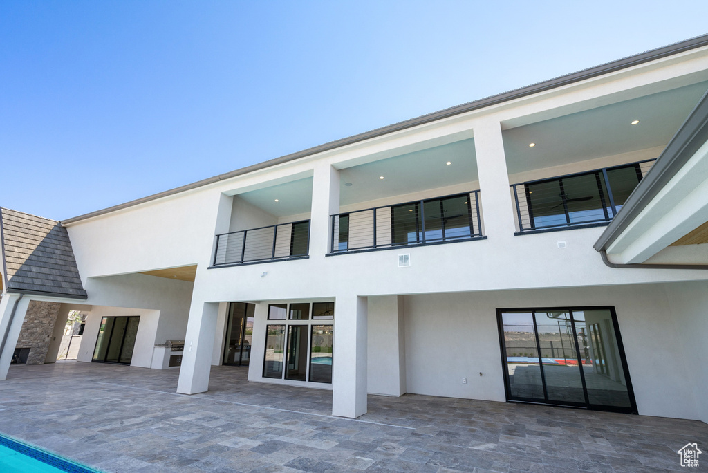 Back of house featuring a patio area and a balcony