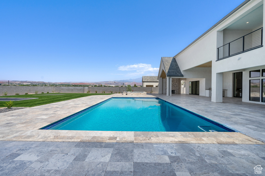 View of pool featuring a yard and a patio