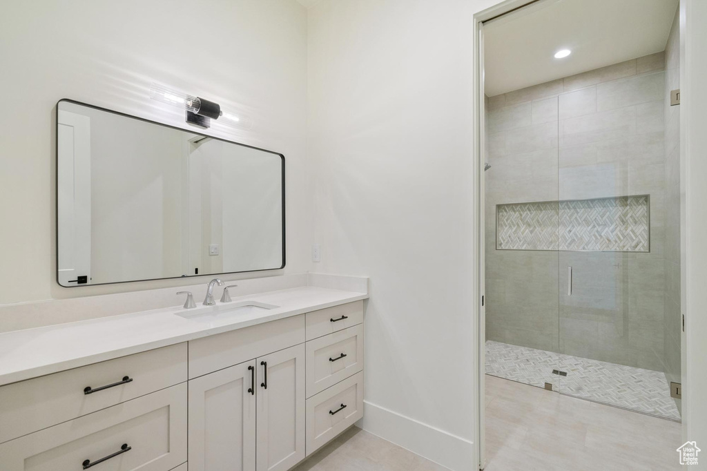 Bathroom featuring vanity and an enclosed shower