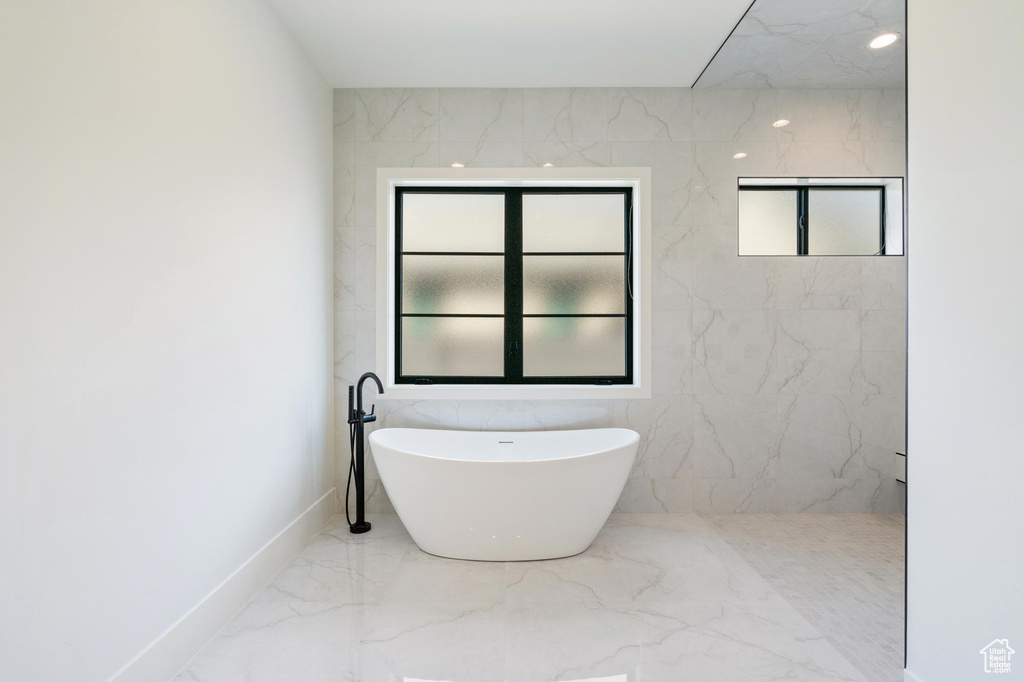 Bathroom featuring a tub to relax in