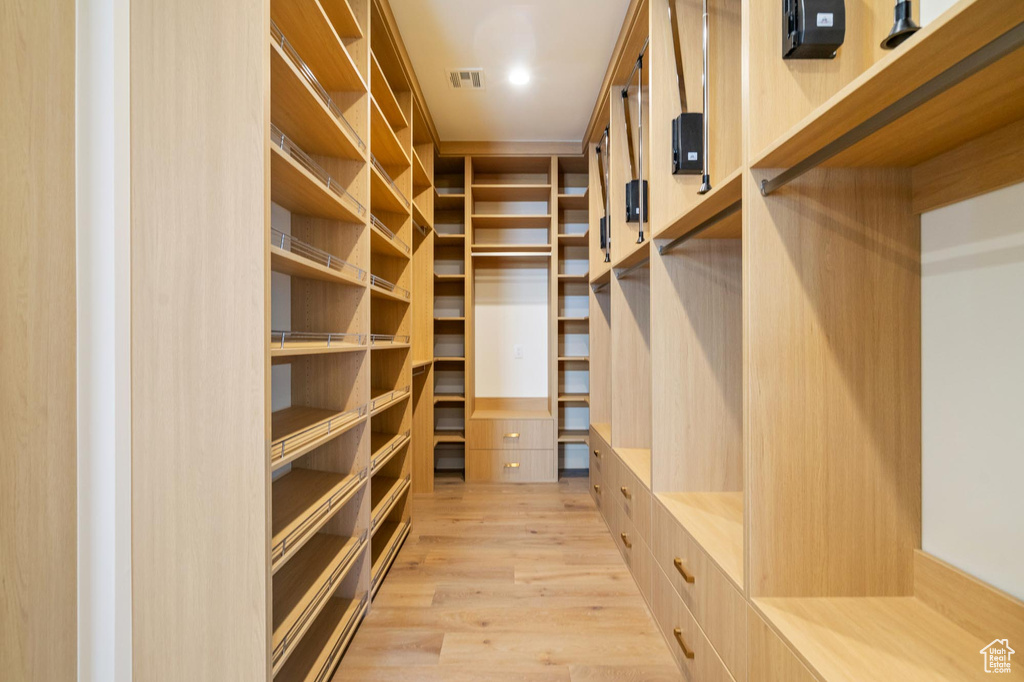 Spacious closet featuring light wood-type flooring