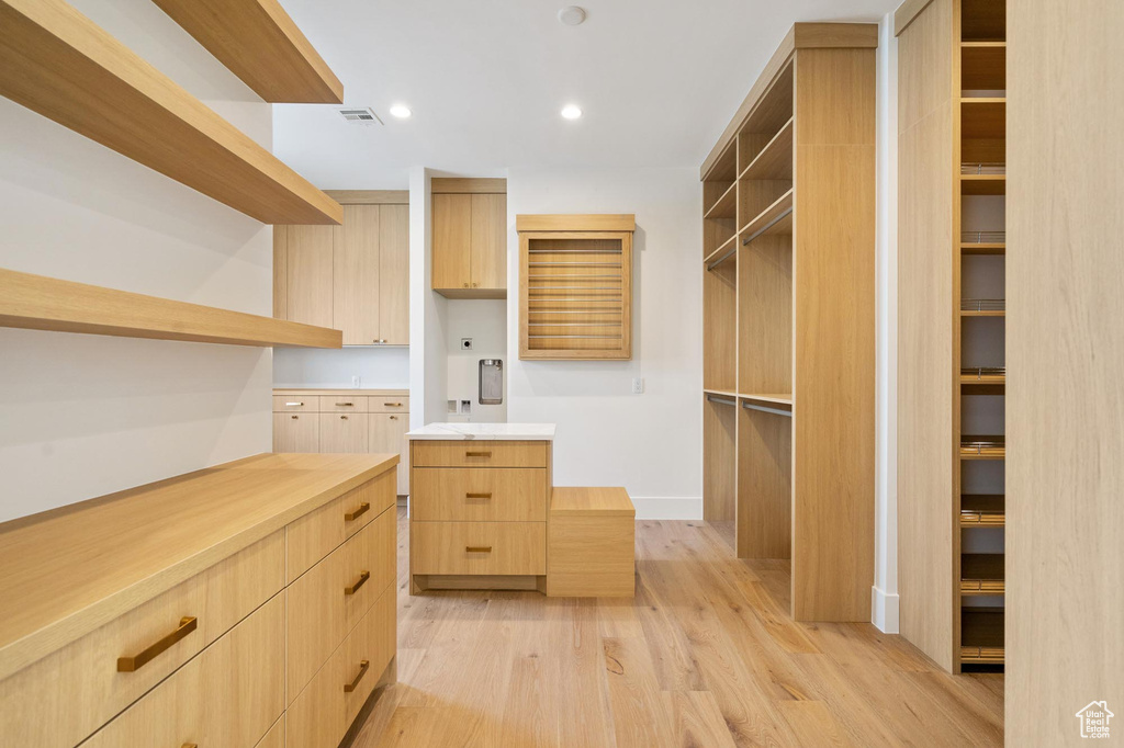 Spacious closet with light wood-type flooring