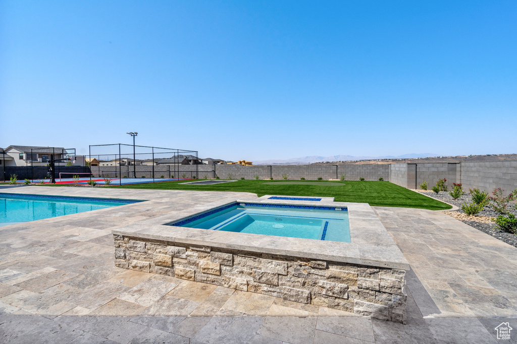 View of pool featuring an in ground hot tub and a patio area