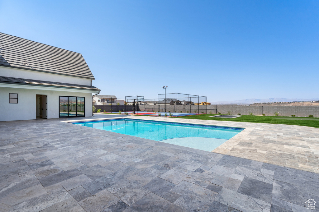 View of pool with a mountain view and a patio area