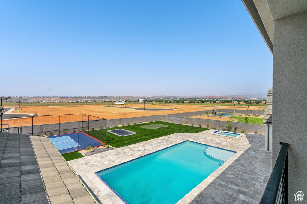 View of swimming pool featuring a yard and a patio area