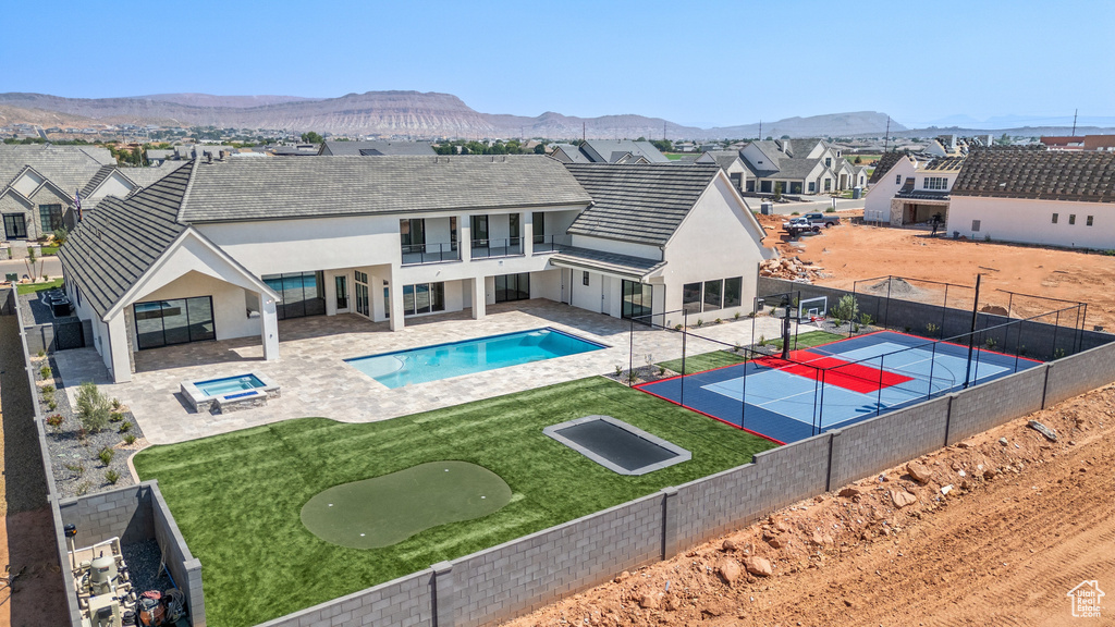 View of pool featuring a mountain view, a yard, and a patio