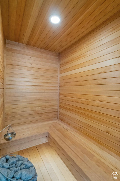 View of sauna / steam room with wood walls and wood ceiling