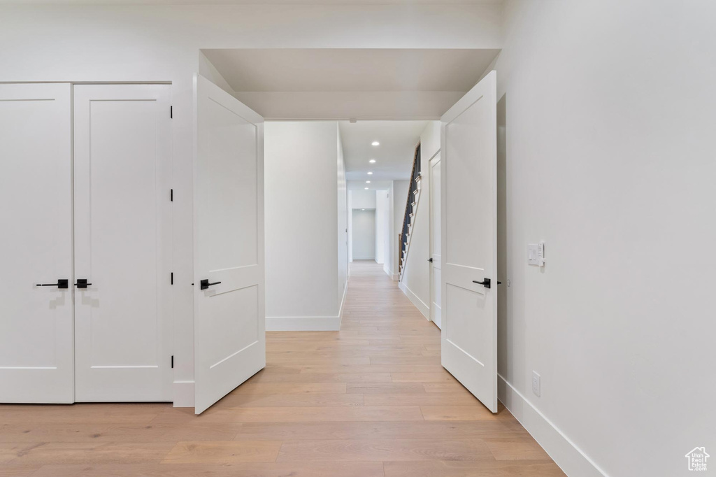 Hall with light hardwood / wood-style flooring