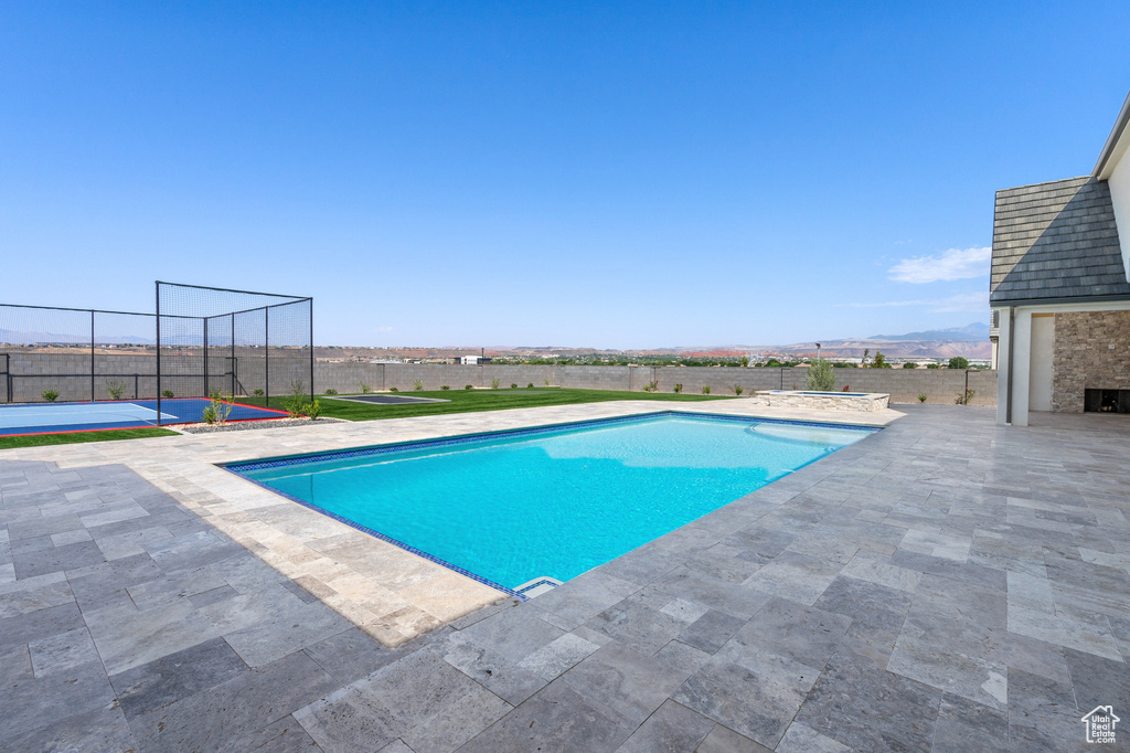 View of swimming pool featuring a mountain view and a patio area