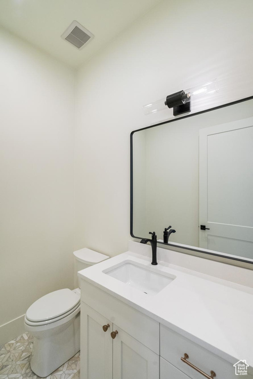 Bathroom featuring toilet and vanity