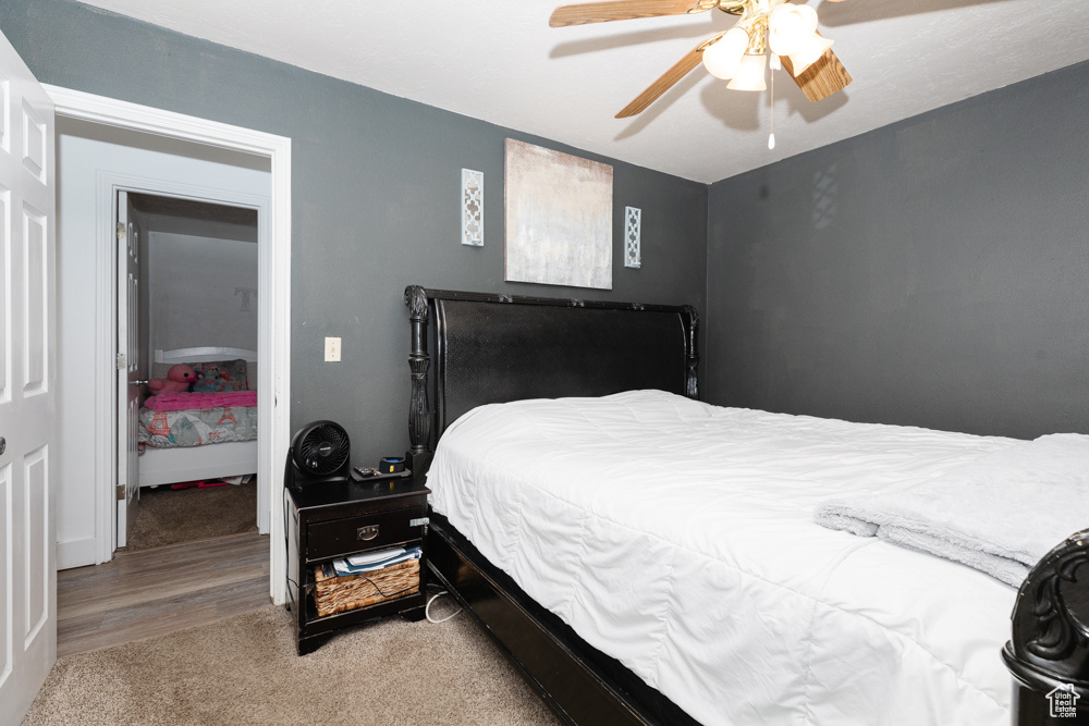 Bedroom with a closet, ceiling fan, and carpet floors