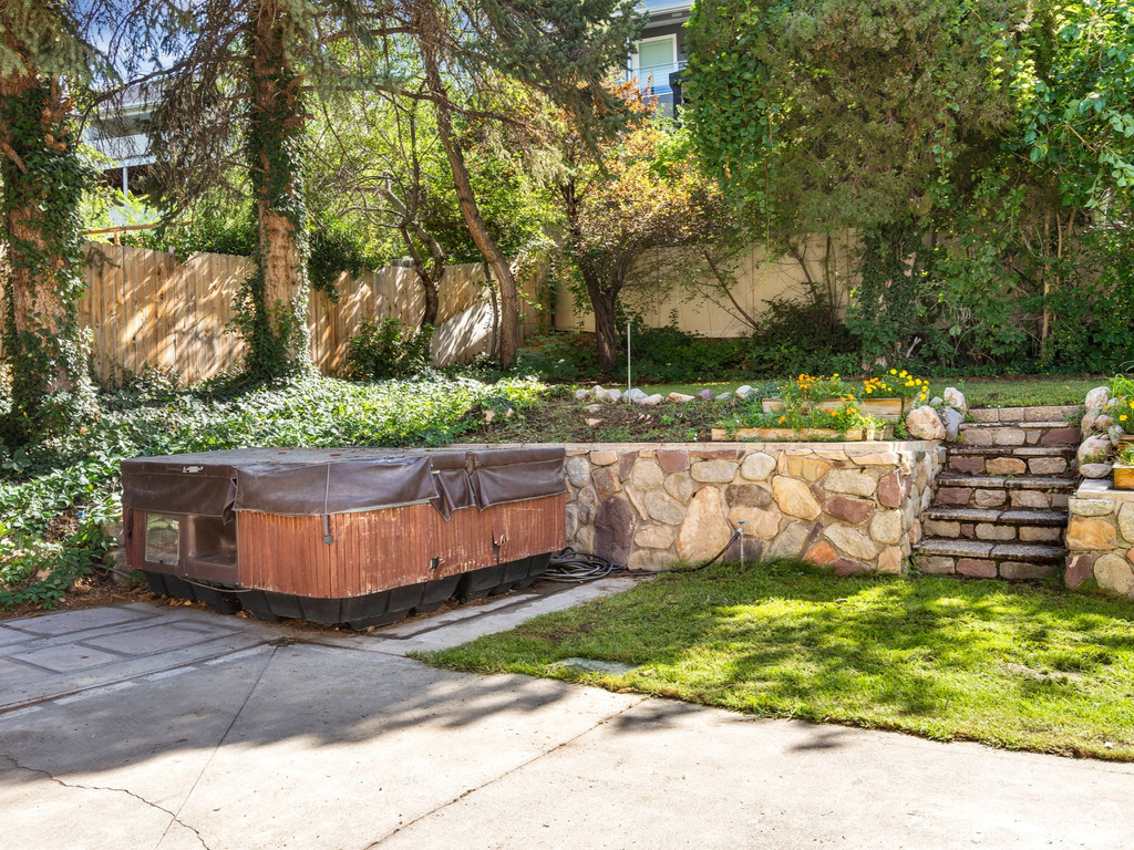 View of patio with a hot tub