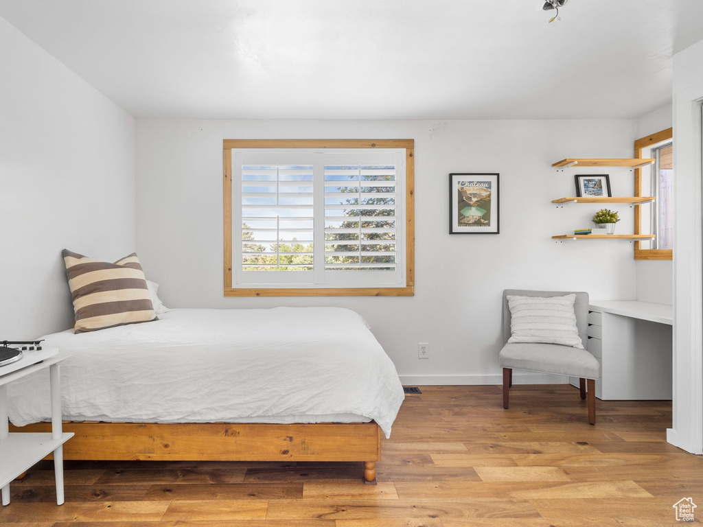 Bedroom with light hardwood / wood-style floors