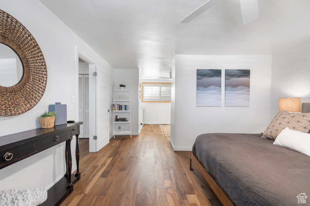 Bedroom with ceiling fan and dark wood-type flooring