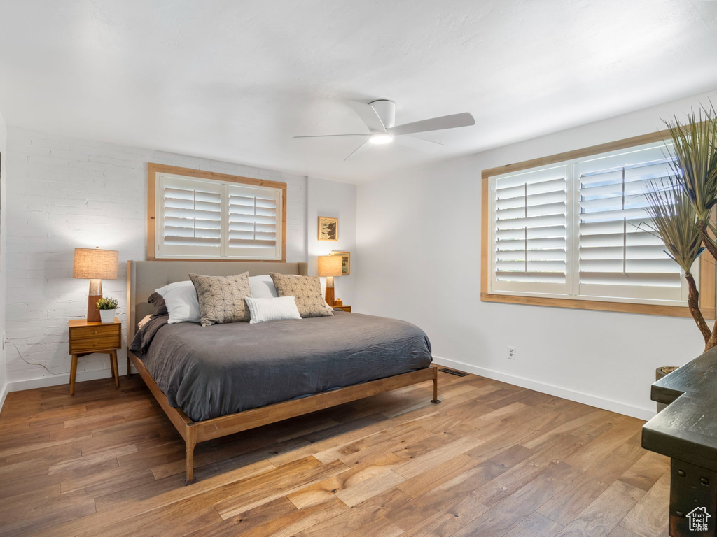 Bedroom featuring ceiling fan and hardwood / wood-style floors