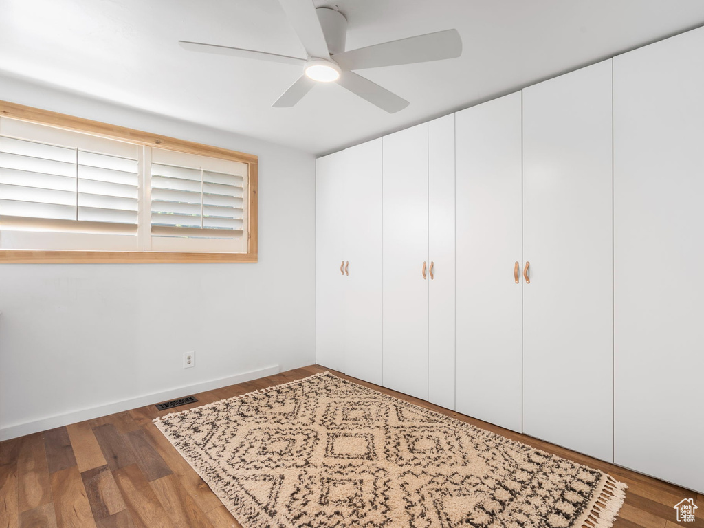 Bedroom featuring hardwood / wood-style floors, a closet, and ceiling fan