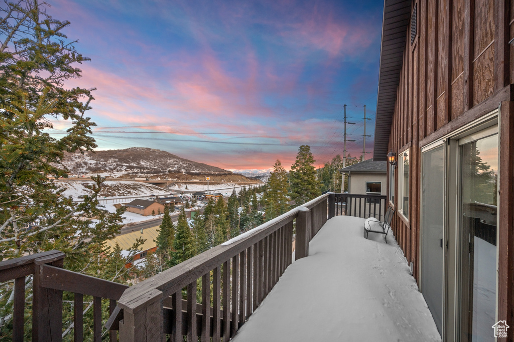 Snow covered back of property featuring a mountain view