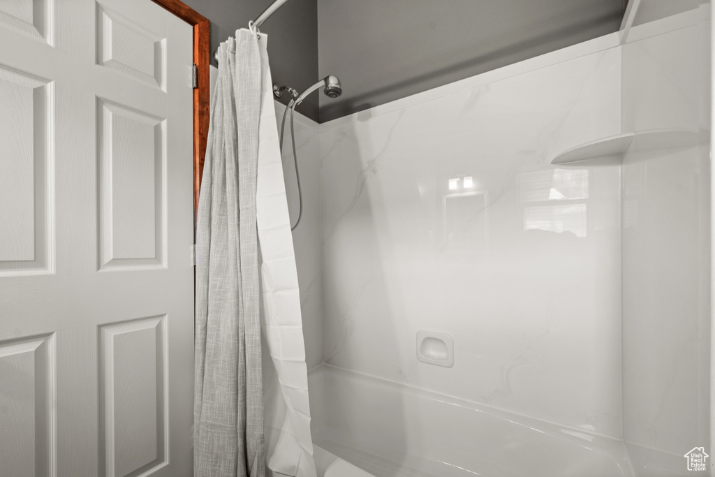 Bathroom featuring shower / tub combo with curtain