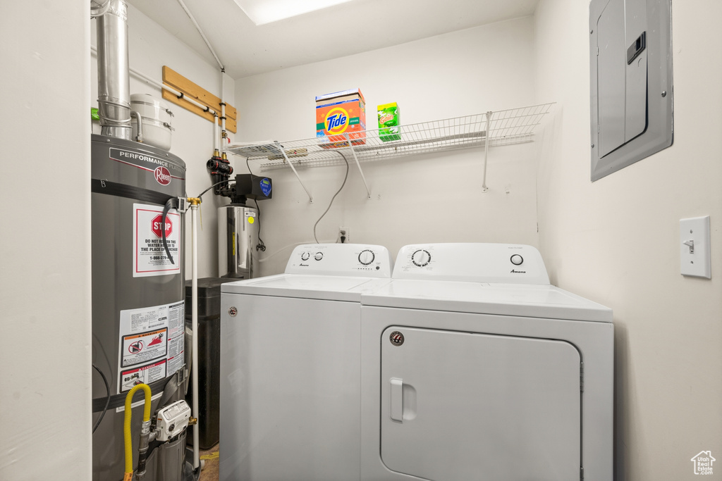 Laundry room featuring washer and clothes dryer and water heater