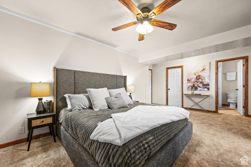 Bedroom with ceiling fan, ensuite bath, ornamental molding, and carpet flooring