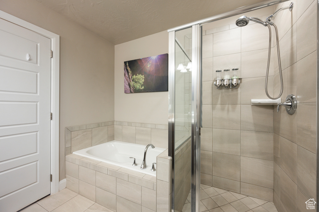 Bathroom featuring independent shower and bath and tile floors