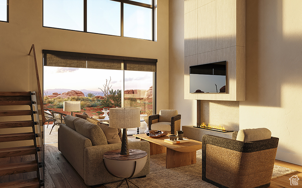 Living room with a high ceiling and wood-type flooring