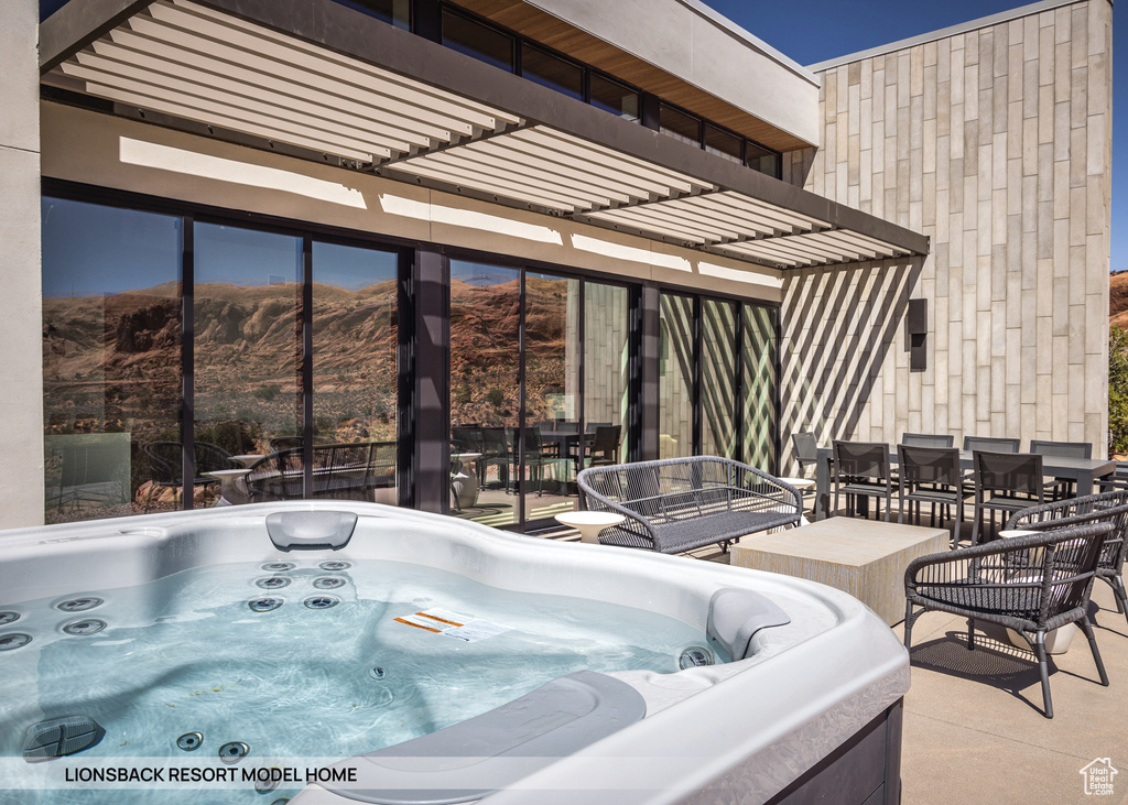 View of swimming pool featuring a mountain view and a hot tub