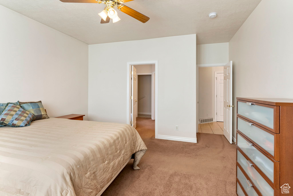 Carpeted bedroom with ceiling fan