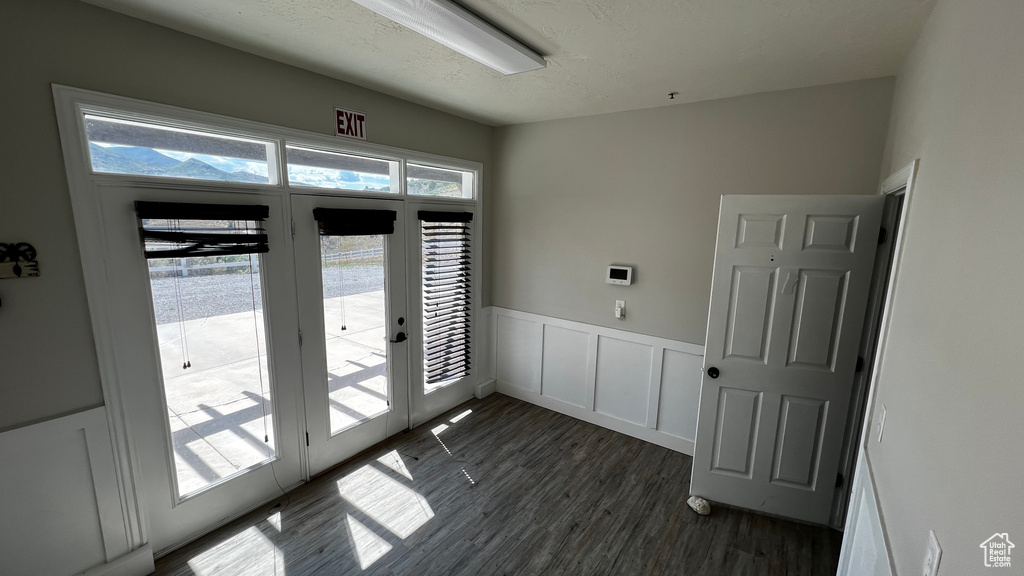 Doorway with dark wood-type flooring and french doors