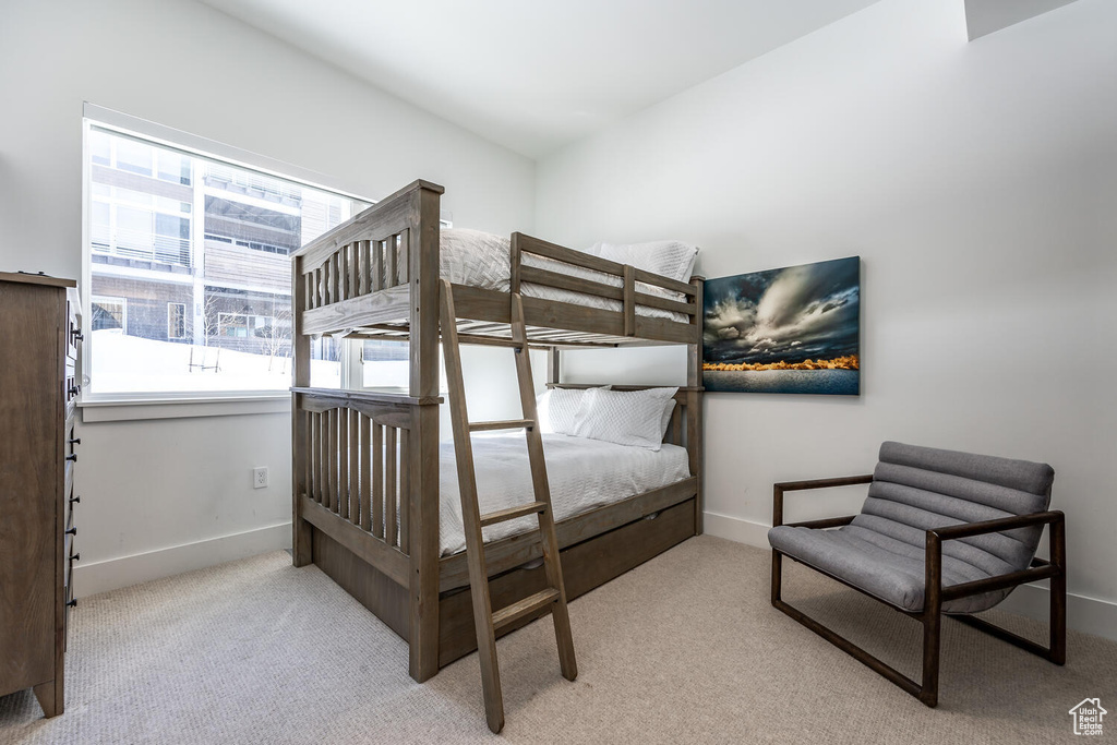 Bedroom featuring light colored carpet