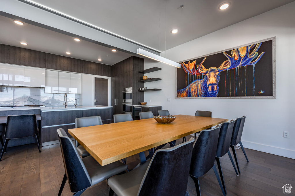 Dining space with sink and dark hardwood / wood-style flooring