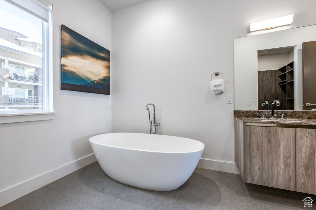 Bathroom featuring tile flooring and vanity