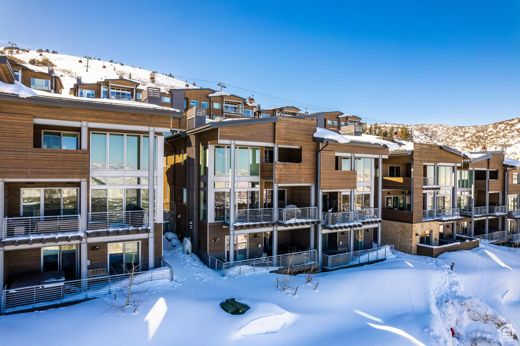 Snow covered property featuring a mountain view