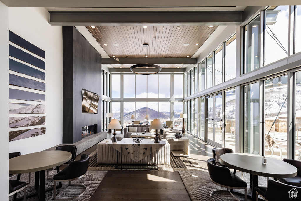 Sunroom / solarium with wooden ceiling and a mountain view