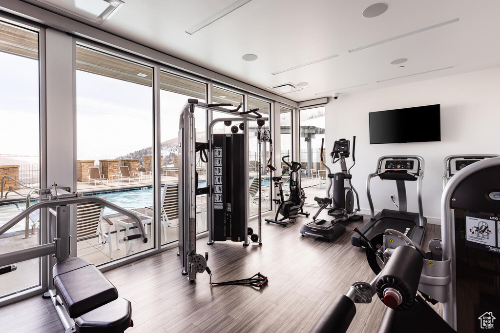 Workout area with hardwood / wood-style floors