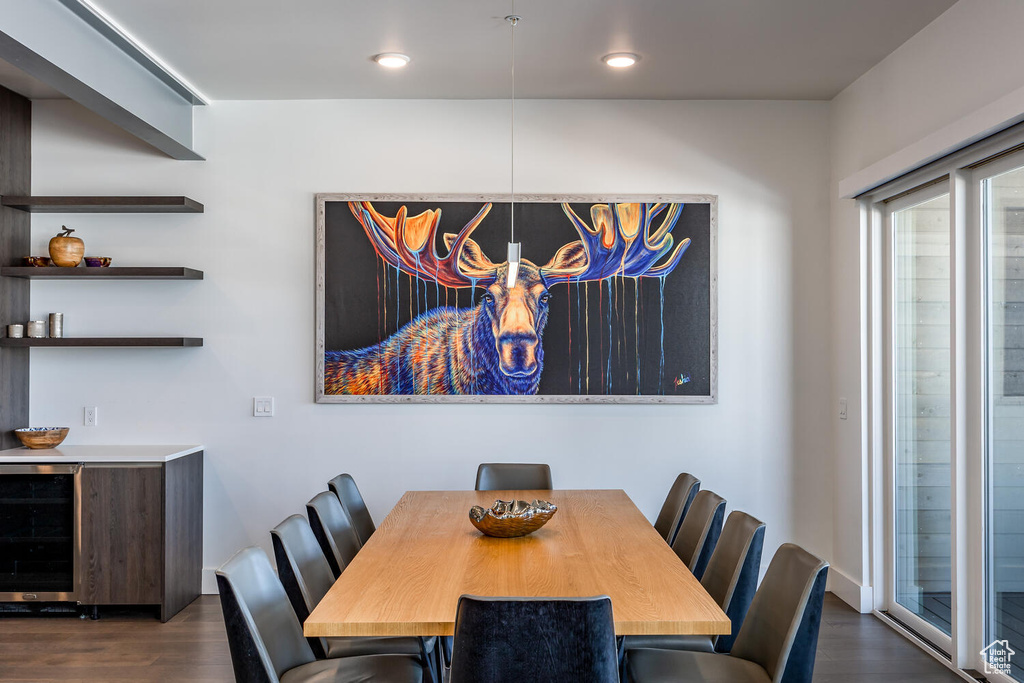 Dining space featuring dark hardwood / wood-style floors and wine cooler