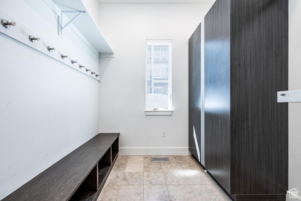 Mudroom featuring light tile floors