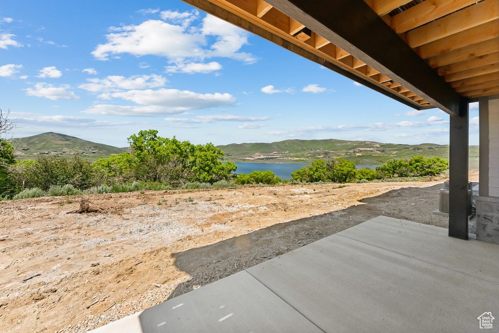 View of patio with a water and mountain view