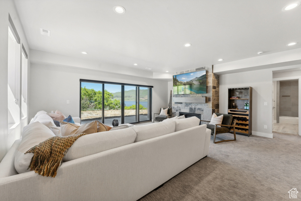 Living room featuring a high end fireplace and carpet flooring