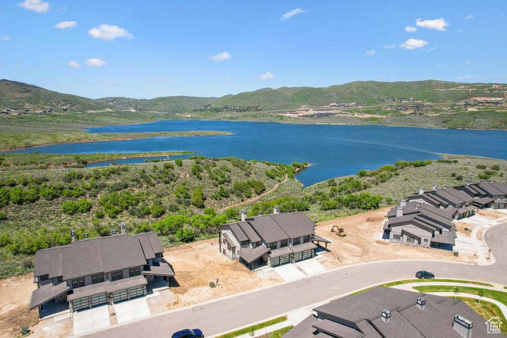 Drone / aerial view featuring a water and mountain view