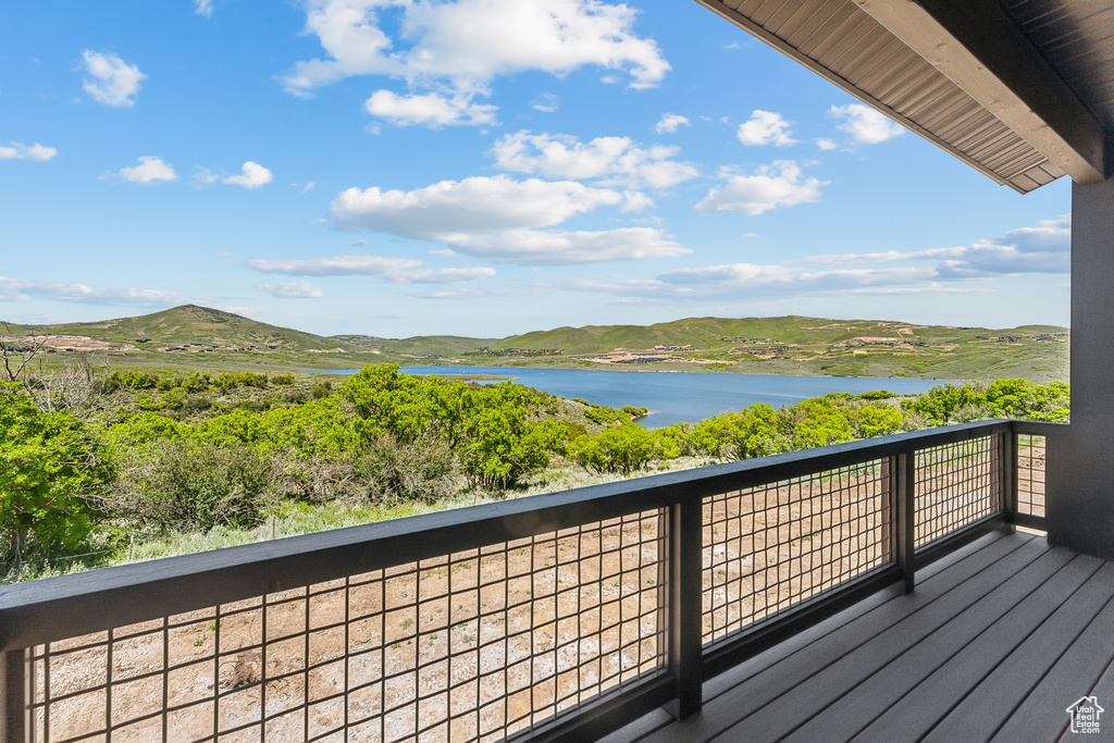 Balcony with a water and mountain view